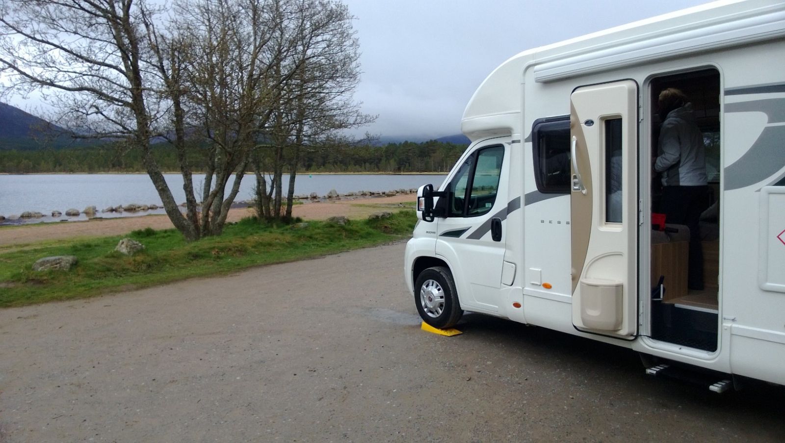 Motorhome parked by banks of loch