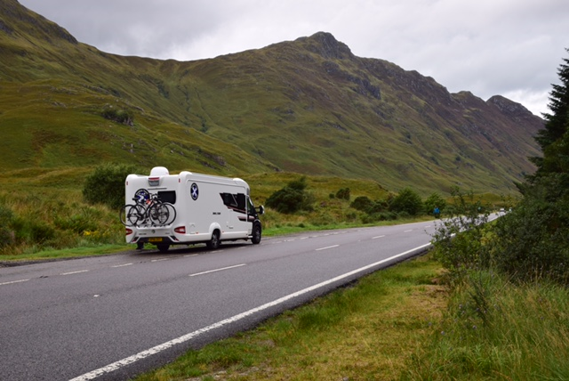 Scottish Tourer motorhome driving through mountain valley