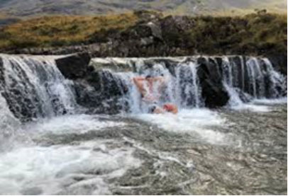 Scottish Tourer customer braving a swim in the fairy pools